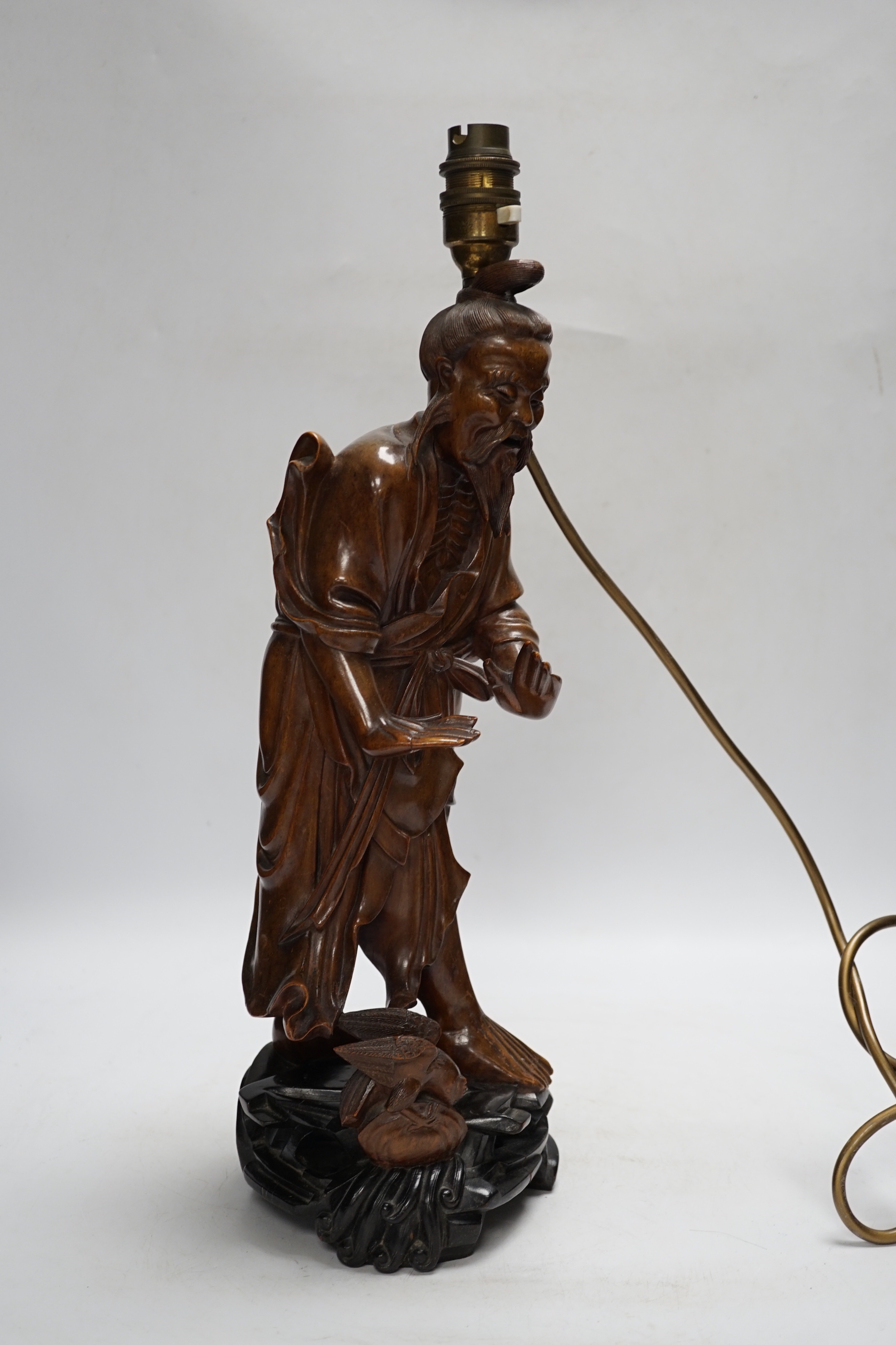 A Chinese carved wood figural table lamp, 43cm total